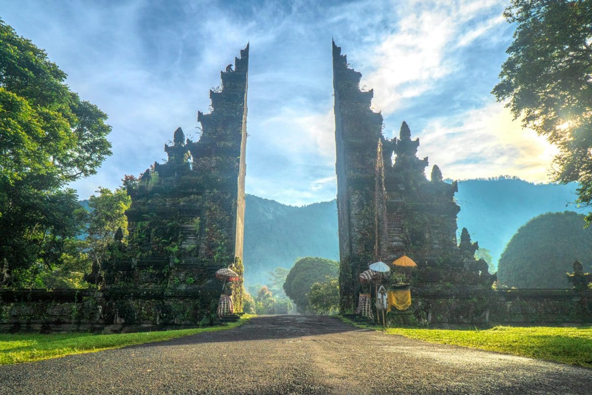 Traditional split temple gate in Bali Indonesia surrounded by lush greenery
