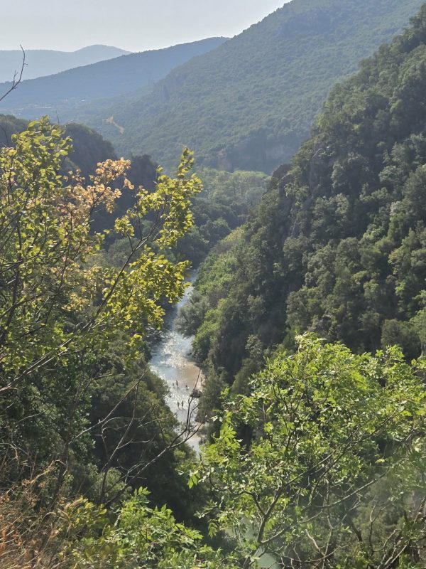 View of the Acheron River flowing through a green canyon in Epirus, Greece