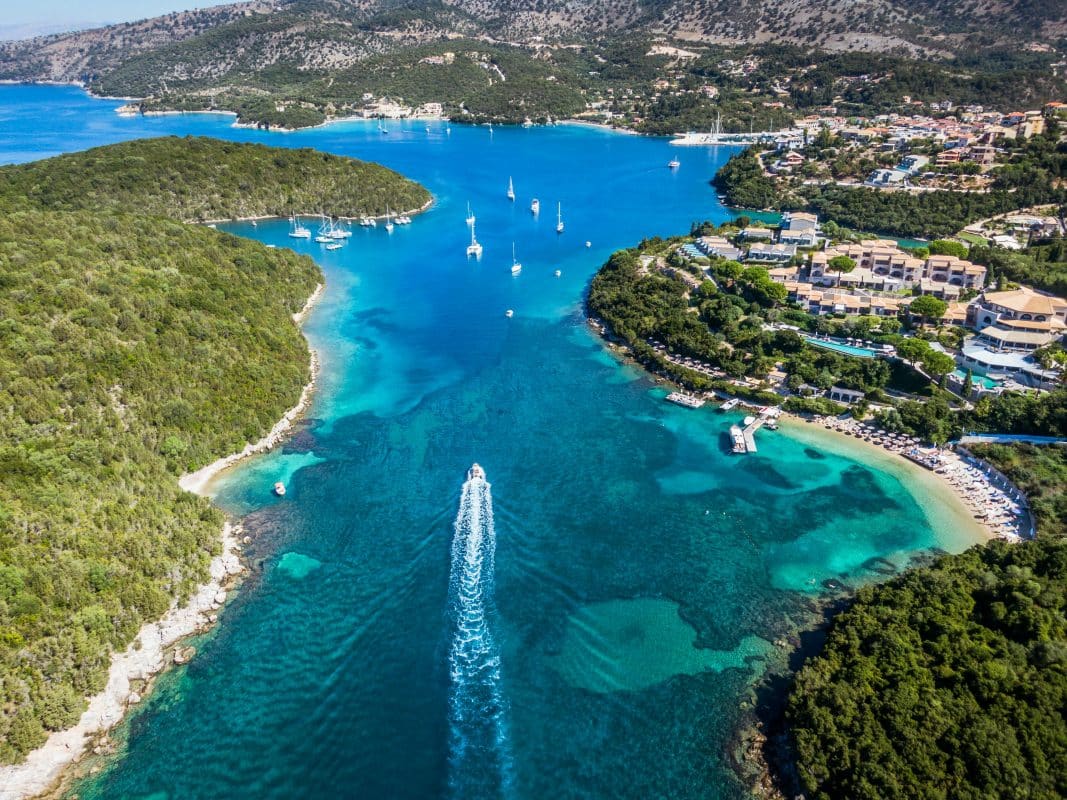 Aerial view of Syvota beaches in Epirus Greece with turquoise water, boats, and coastal village