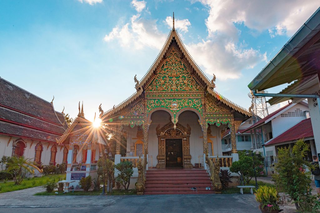 Ornate Buddhist temple in Chiang Mai Thailand at sunset