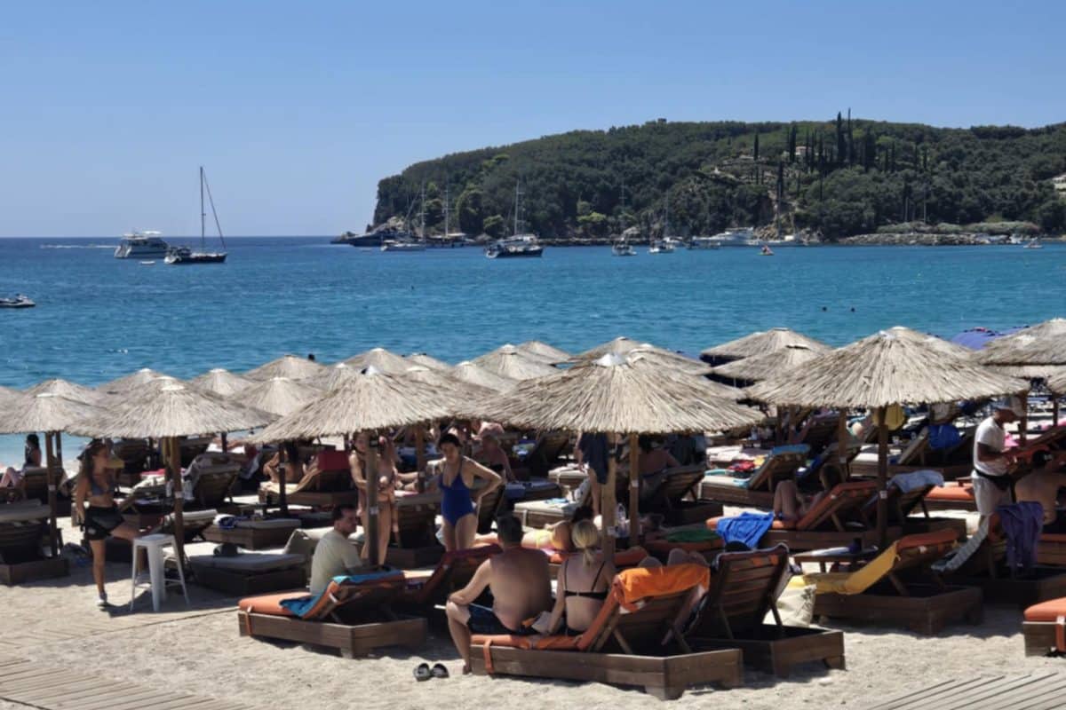 Valtos Beach near Parga in Epirus Greece with beach umbrellas and turquoise Ionian Sea water