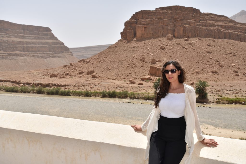Woman standing by desert river landscape in Morocco