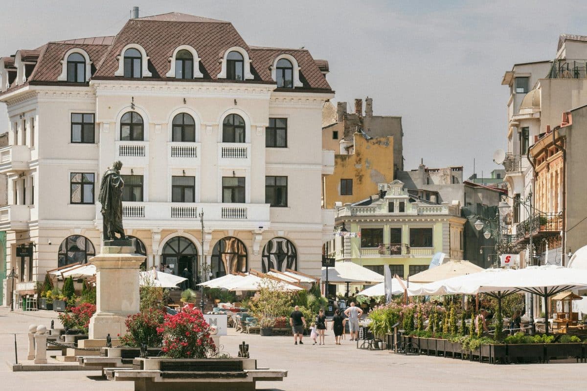 Charming Old Town square in Constanța Romania with cafes, historic buildings, and statue in the city center