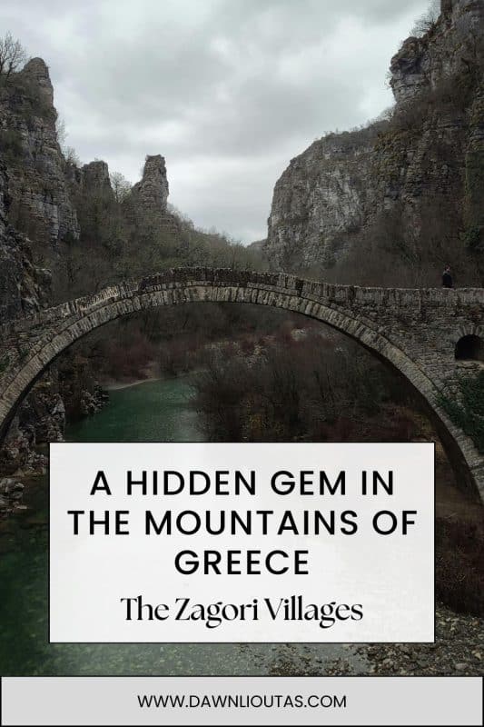 Historic stone bridge in the Zagori Villages surrounded by dramatic mountain cliffs and a river in Northern Greece.