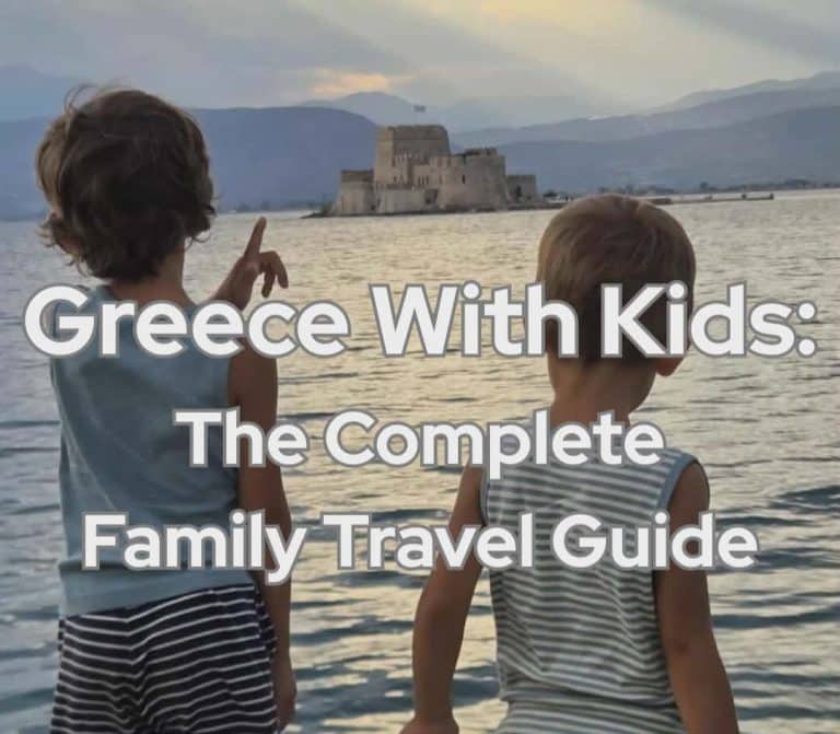 Two children looking toward Bourtzi Castle in Nafplio, Greece at sunset during a family trip.