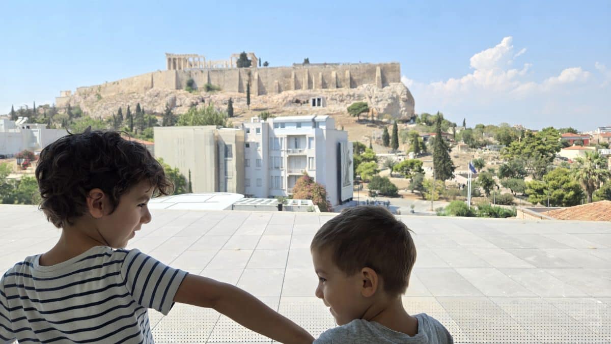 Kids looking at the Acropolis in Athens during a family trip to Greece