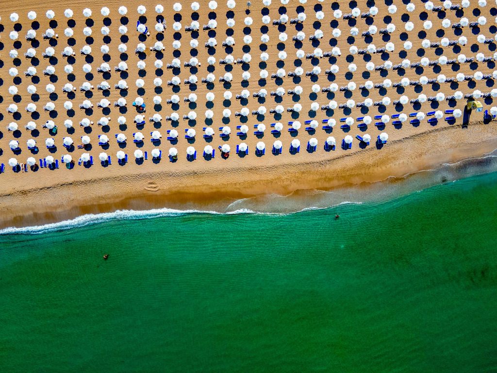 Aerial view of beach umbrellas along the black sea coastline.