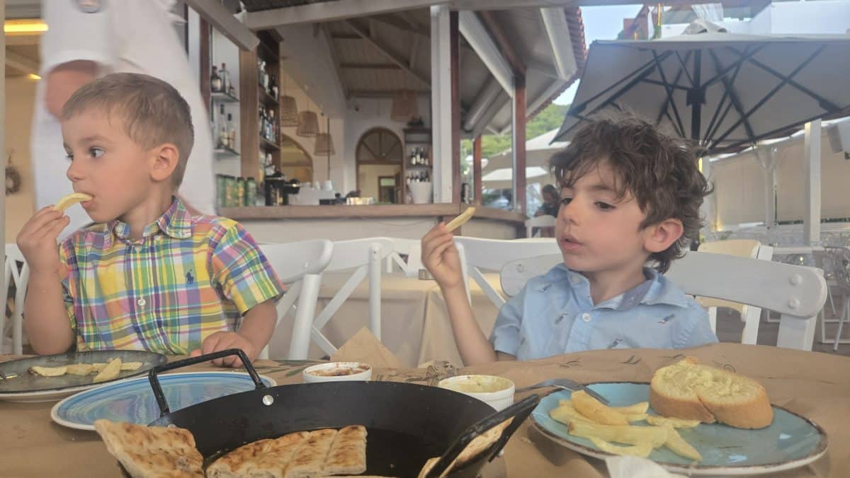 Kids eating at a family-friendly restaurant in Greece during a family vacation