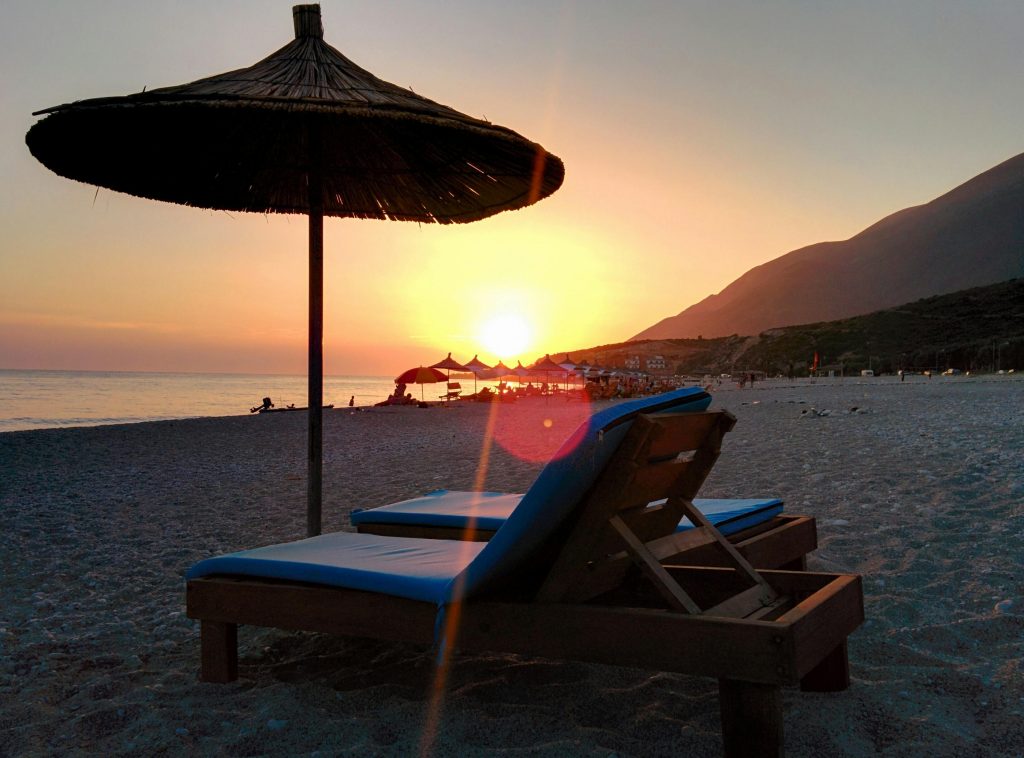 Sunset over a beach with loungers in Sarande Albania on the Ionian coast