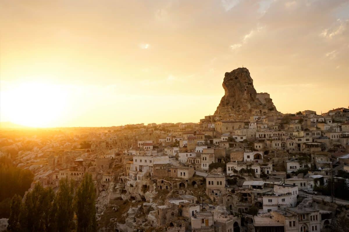 Ortahisar Castle in Cappadocia at sunset overlooking cave houses and landscape