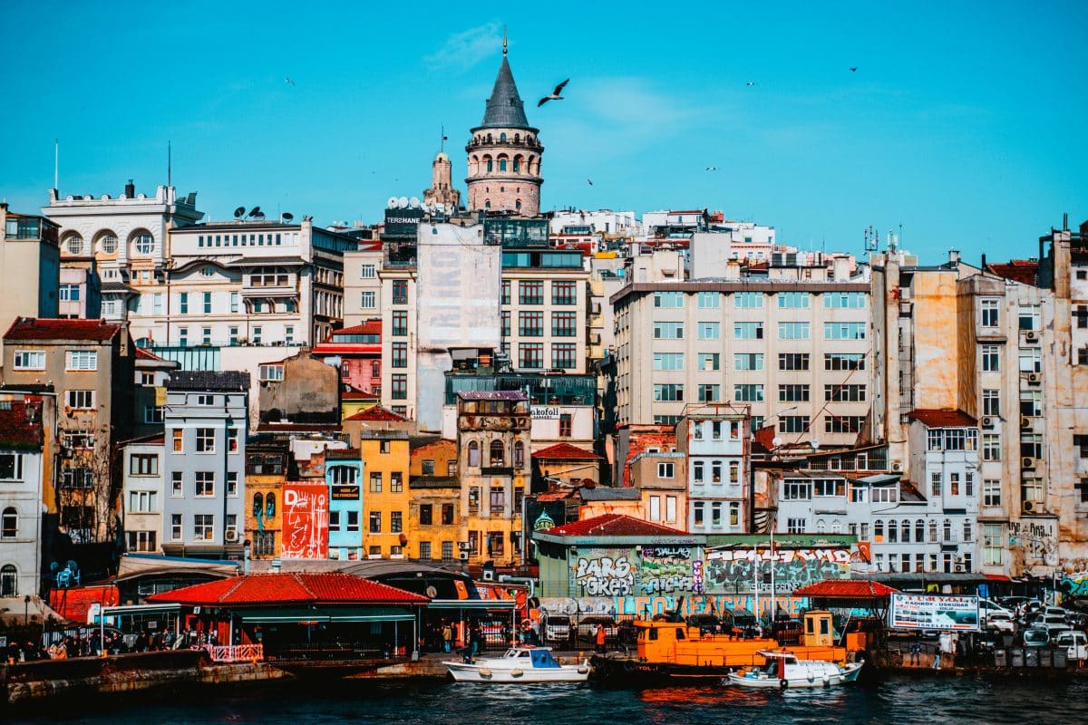 Galata Tower overlooking colorful buildings and waterfront in Istanbul Turkey
