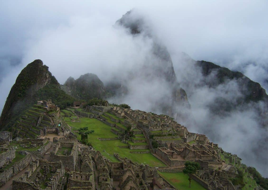 Machu Picchu ruins surrounded by clouds and mist Peru mountain view