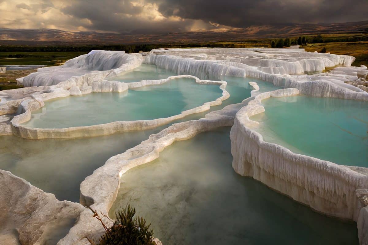Pamukkale white travertine terraces with turquoise thermal pools in Turkey