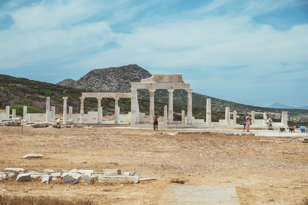 Temple of Demeter ruins in Naxos, Greece with ancient columns and mountain backdrop