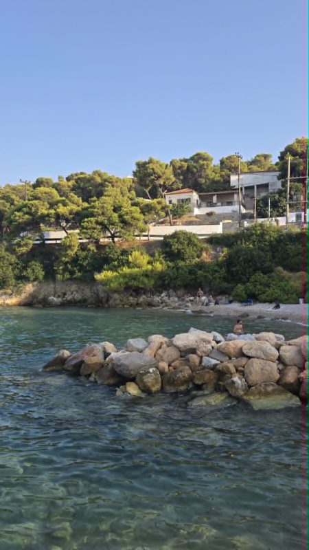 View of Skala port in Agkistri Greece with coastline and clear water