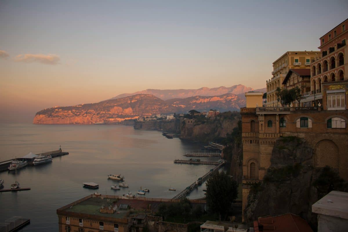 Amalfi Coast near Sorrento Italy at sunset with cliffs, sea views, and coastal buildings