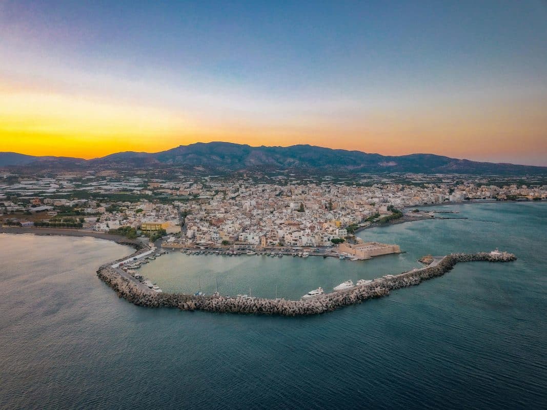 Aerial view of Ierapetra Crete at sunset with harbor coastline and mountains
