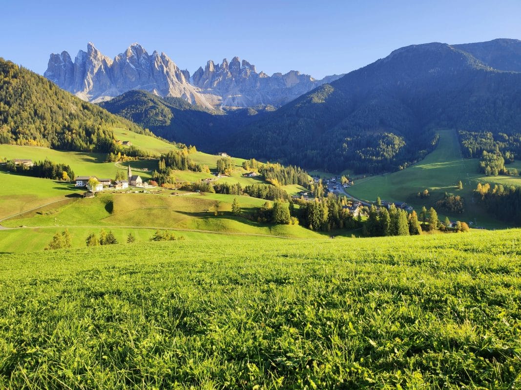 Val di Funes in the Dolomites Italy with green valley, small village, and dramatic mountain peaks
