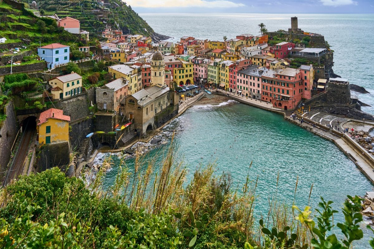 Colorful coastal village of Vernazza in Cinque Terre Italy with harbor and ocean views