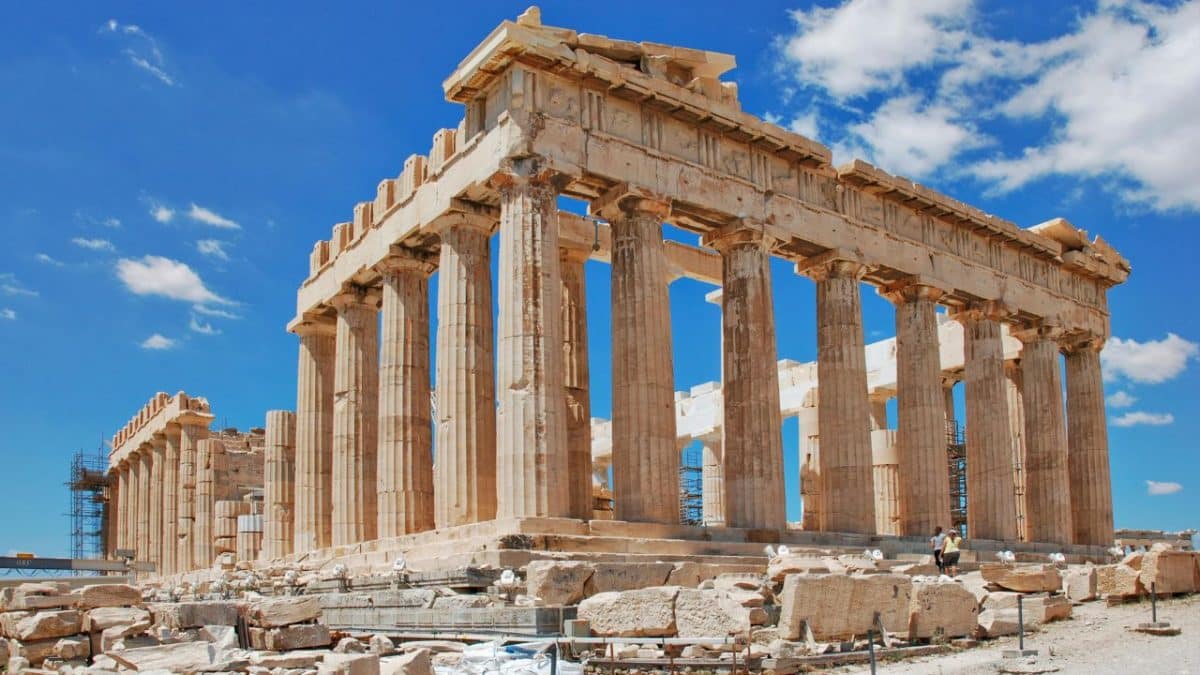 The Parthenon at the Acropolis in Athens, Greece under a bright blue sky