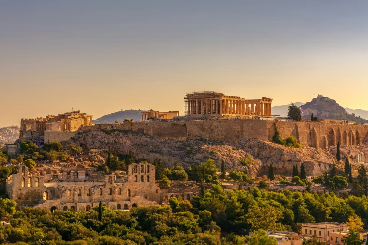 Sunset view of the Acropolis, Odeon of Herodes Atticus, and Lycabettus Hill in Athens, Greece