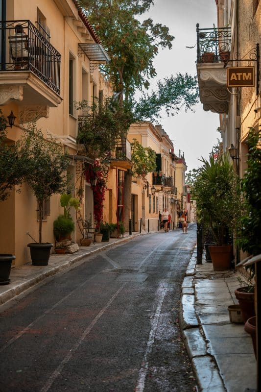 Quiet street in the Plaka neighborhood of Athens with balconies, plants, and traditional buildings