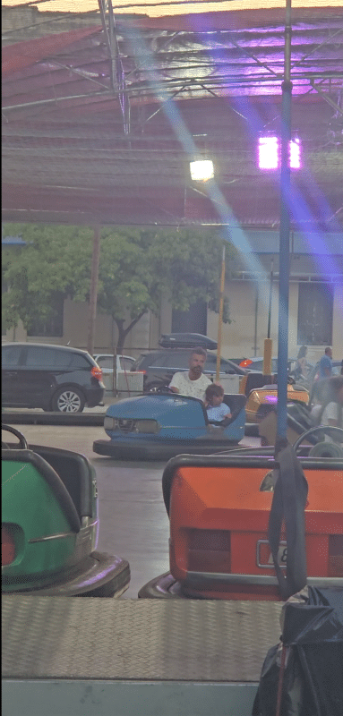 Kids riding bumper cars at Filion Fun Park in Nafplio, Greece