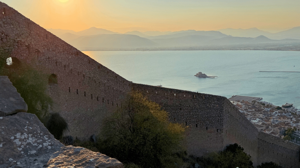 Palamidi Fortress walls overlooking Nafplio and Bourtzi Castle at sunset