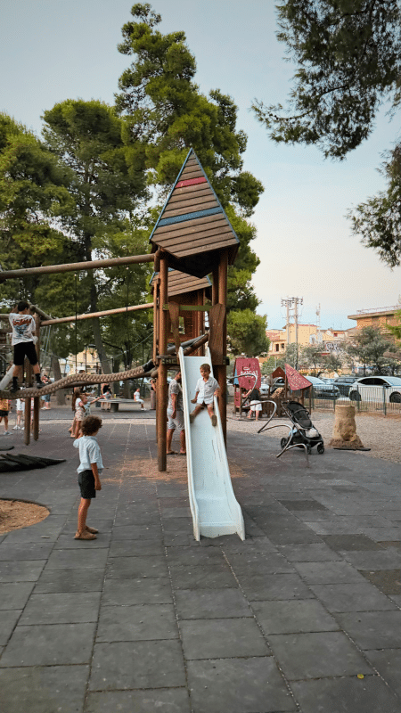 Kids playing at the playground in Kolokotronis Park, Nafplio, Greece