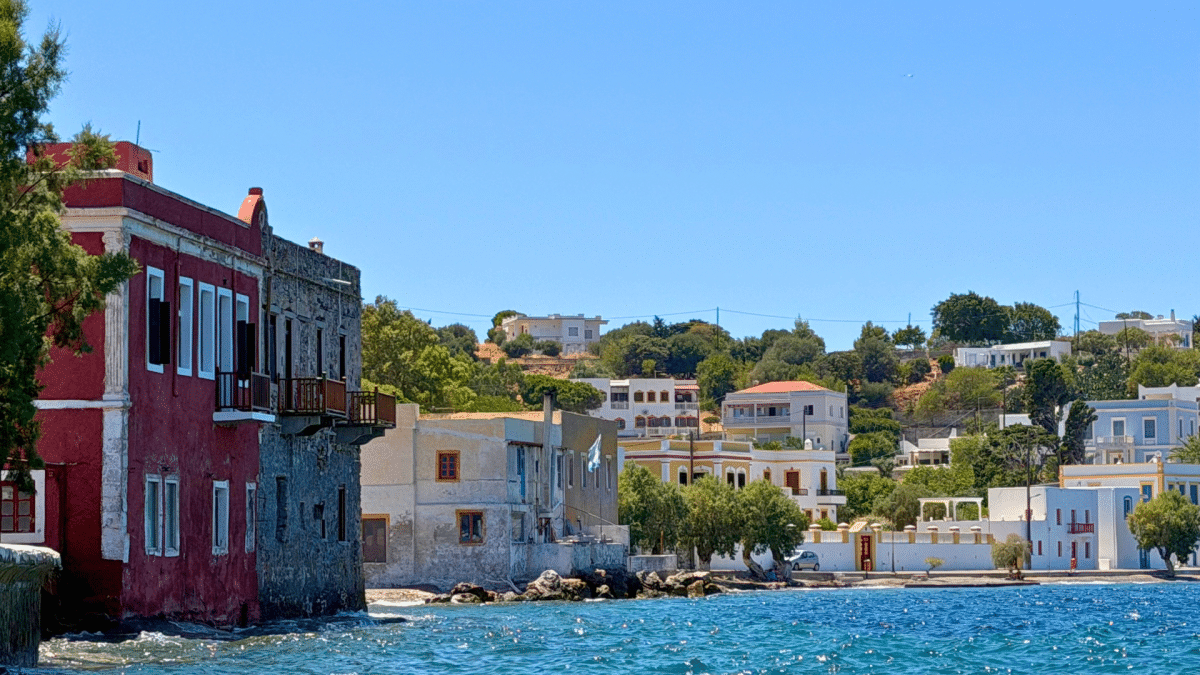 Agia Marina waterfront in Leros, Greece, with colorful traditional houses overlooking the Aegean Sea