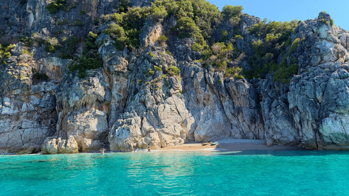 Turquoise water and dramatic rocky cliffs along the Albanian Riviera during a boat tour from Himarë