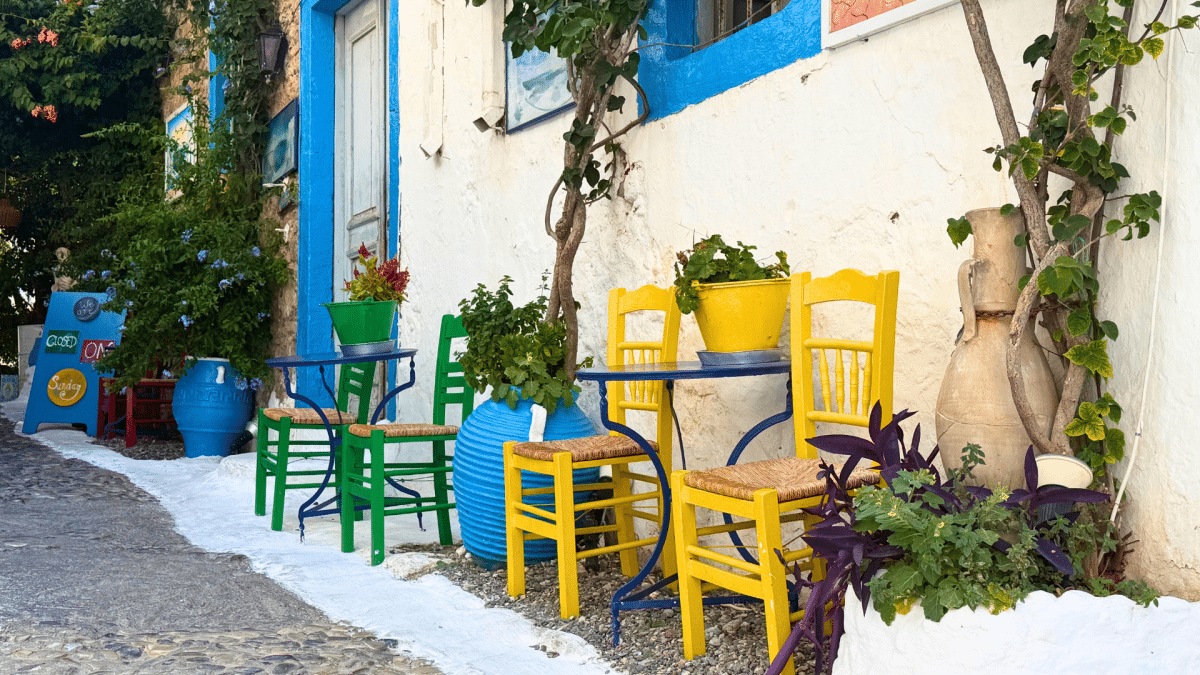 Colorful chairs and tables outside a traditional building in Kos, Greece